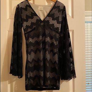 Black lace mini w/tan under long flowing sleeves.